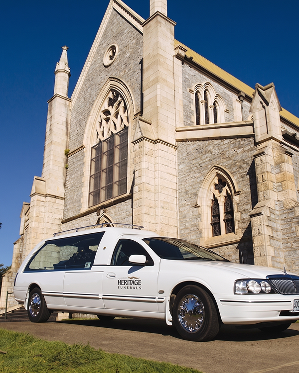 chapel with hearse parked in front